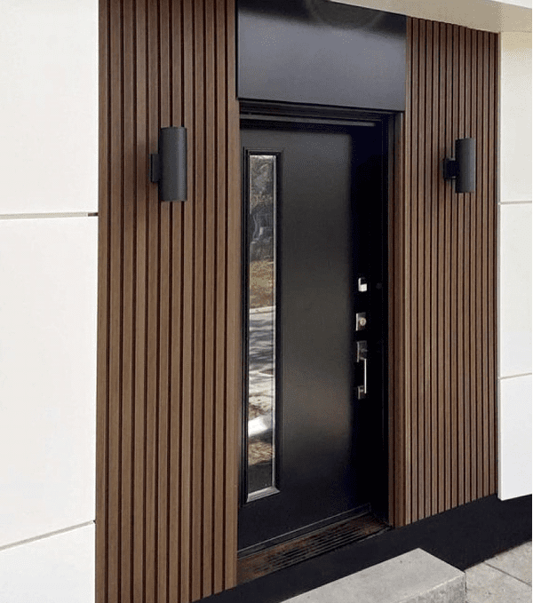 A door with a black metal frame and wood panels.