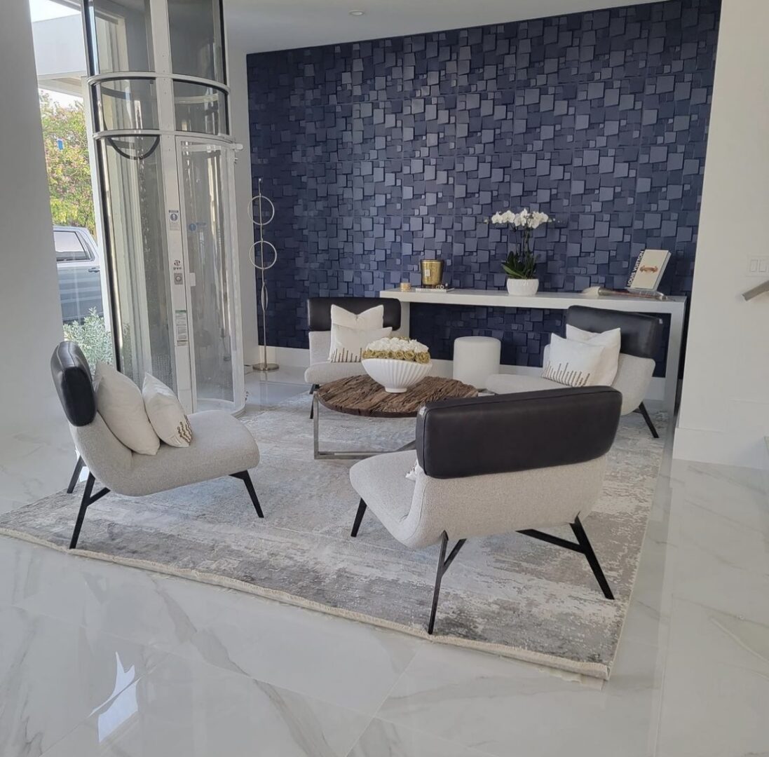 A living room with white furniture and blue walls.