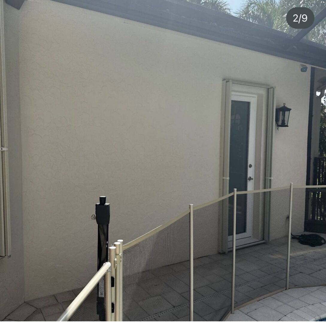 A white door and window with a railing.