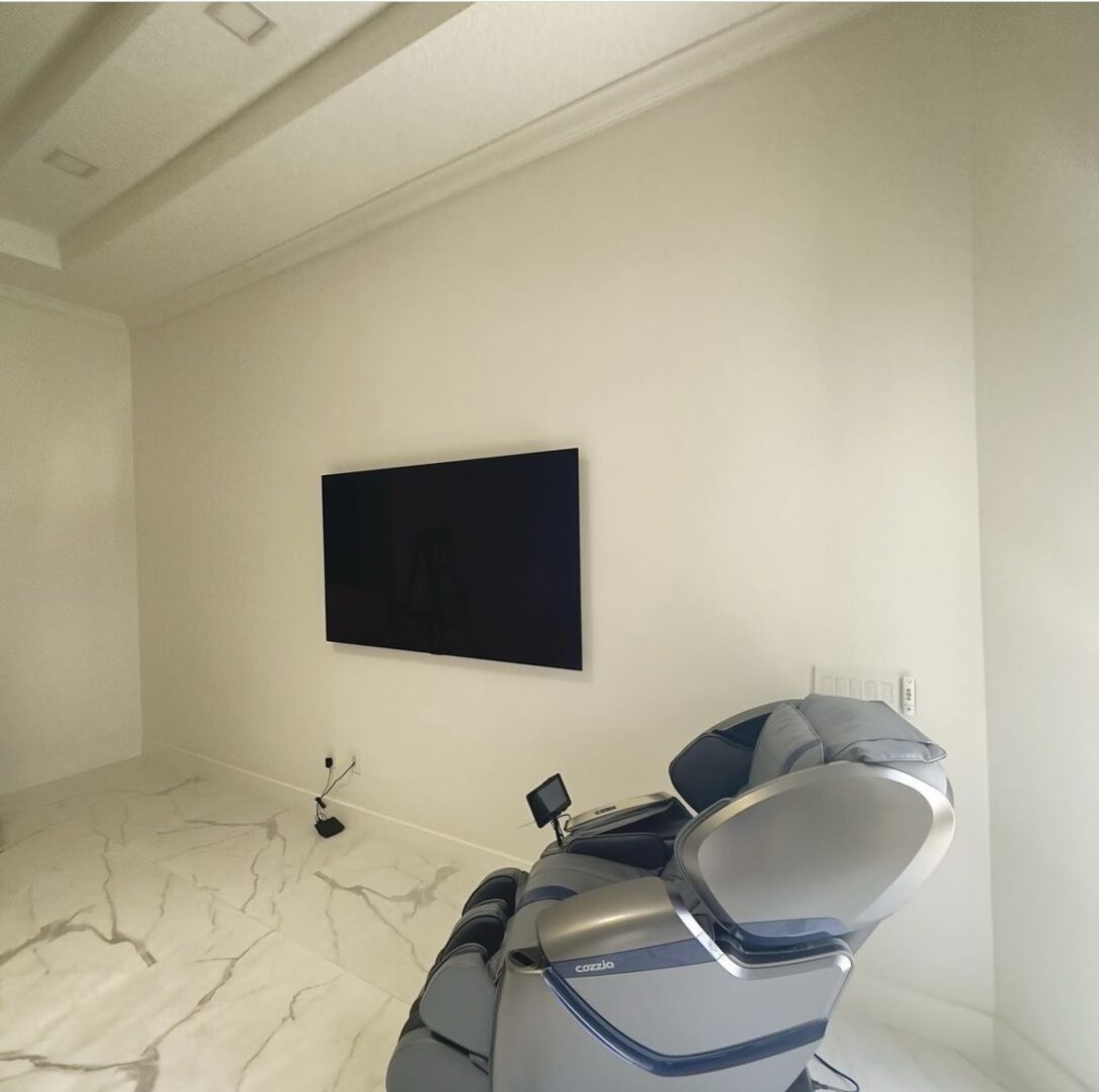 A room with a television and a chair