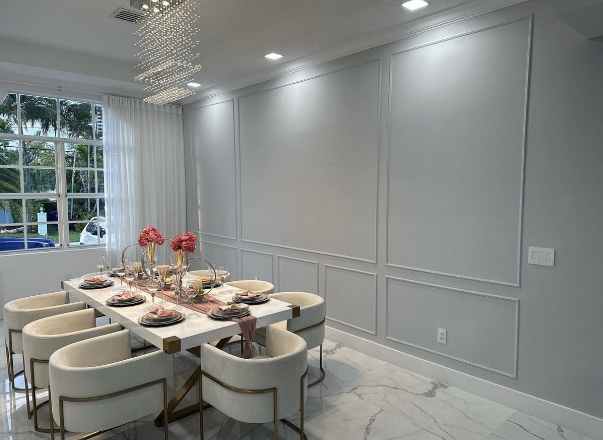 A dining room with white walls and marble floors.