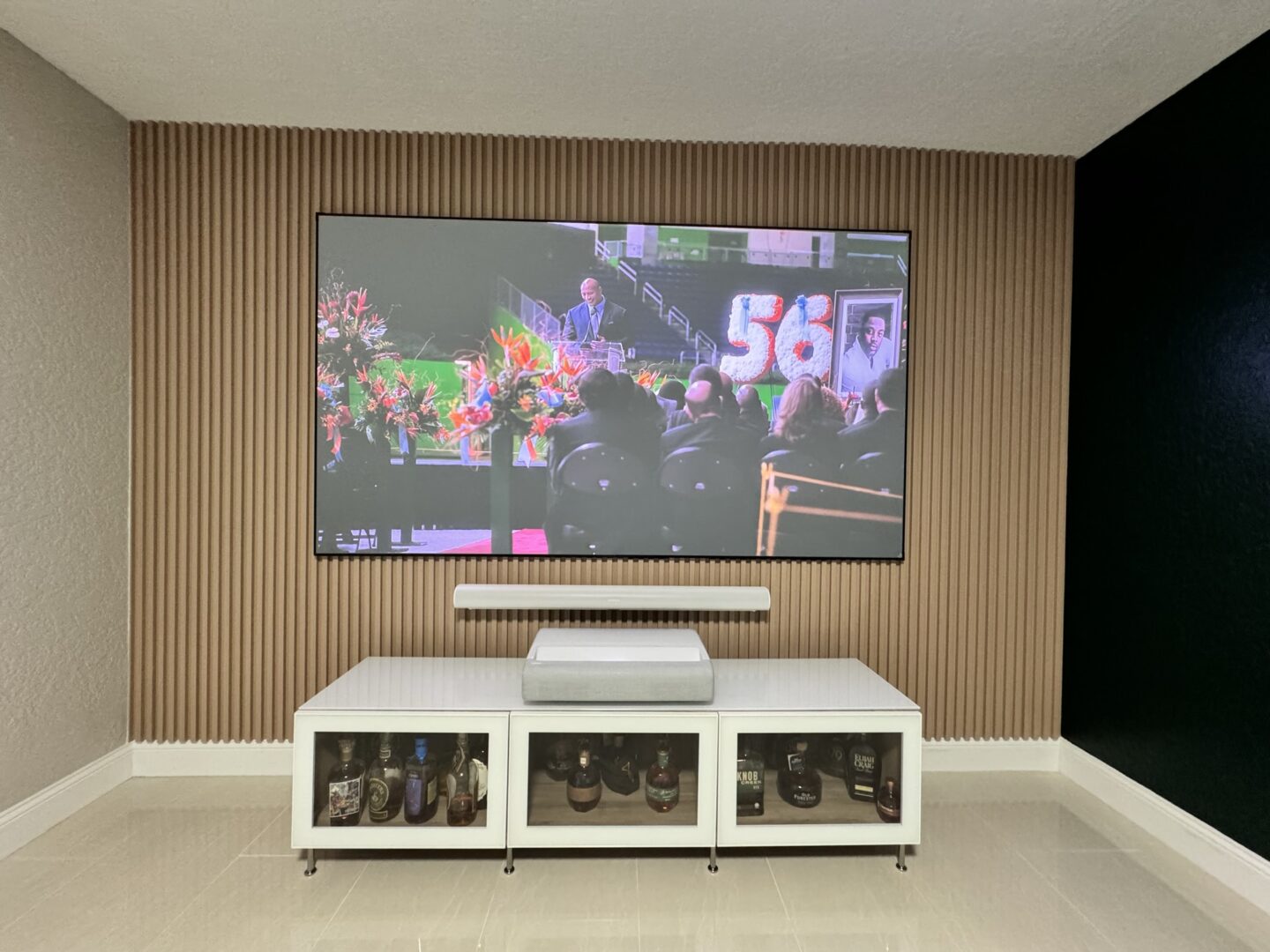 A tv mounted on the wall above a table.