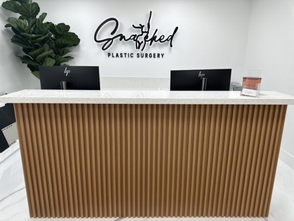 A reception desk with the name of gretchen plastic surgery on it.