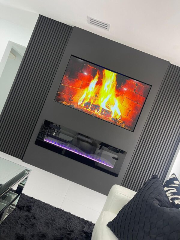 A fireplace with a flat screen tv mounted above it.