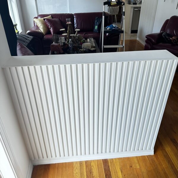 A radiator sitting on the floor of a room.